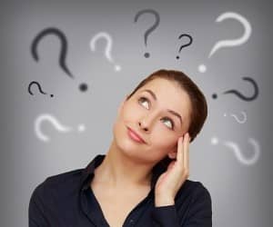 Beautiful Business Woman With Question Mark Above The Head Looki