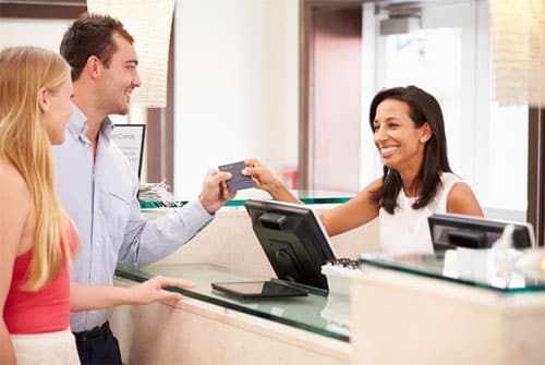 Receptionist permitting visitor entry after verifying credentials