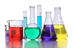 Laboratory glassware with various colored liquids with reflectio